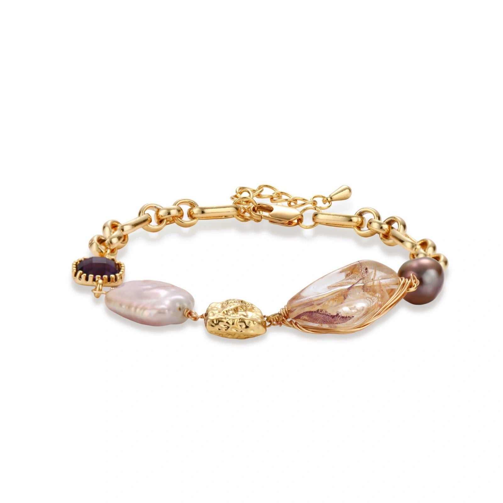 Gold-plated chain bracelet with mixed gemstones including purple stone, baroque pearl, and clear crystal on neutral background.