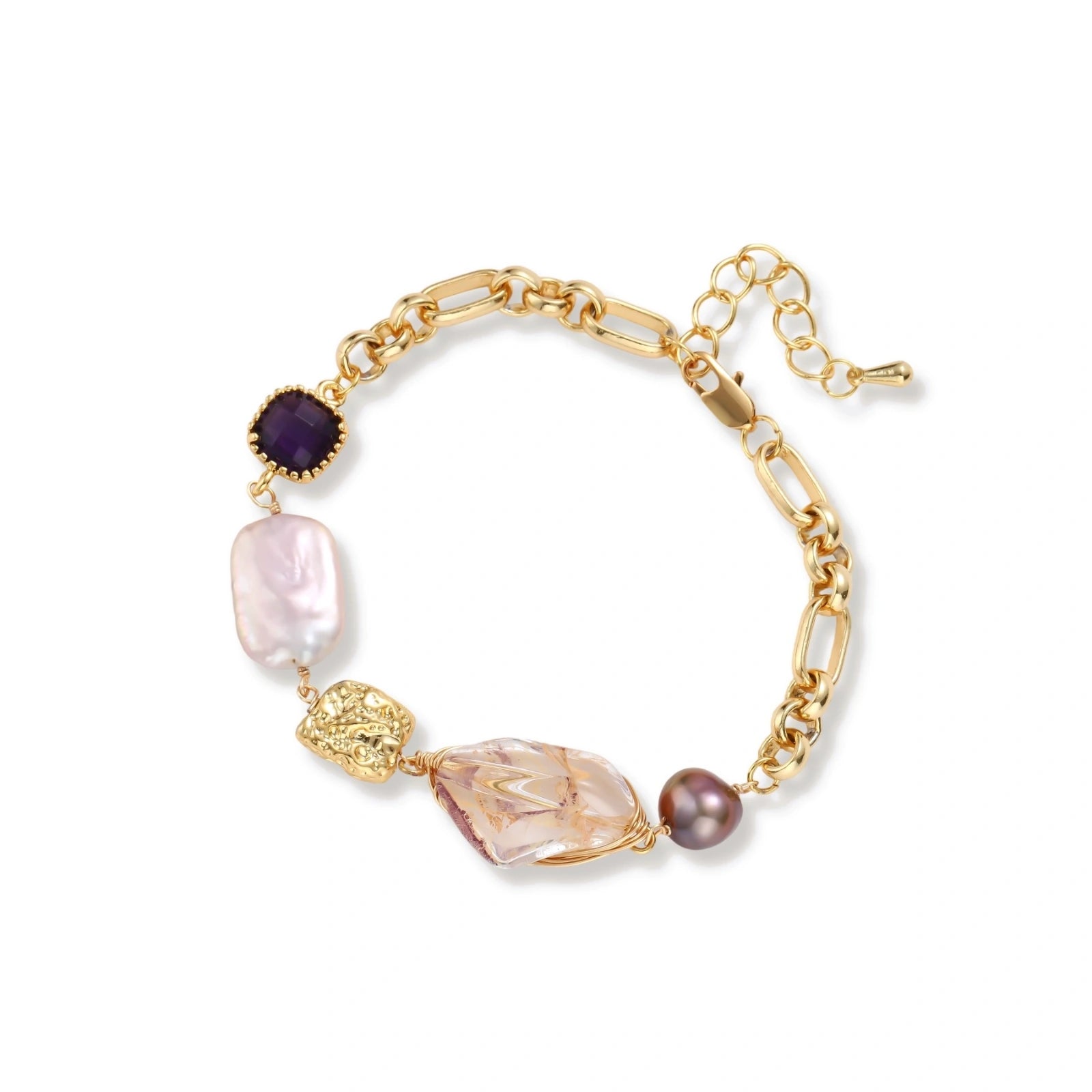 Gold-plated chain bracelet with mixed gemstones including purple stone, baroque pearl, and clear crystal on neutral background.